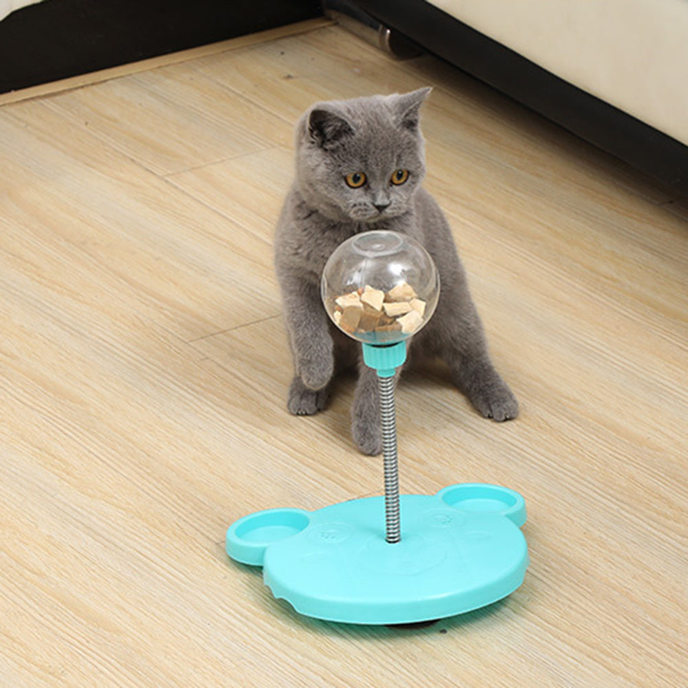 Cat playing with a tumbler treat feeder