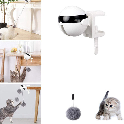 Automatic lifting ball cat toy with a white motor unit, black face and white table clamp, and a grey plush pom-pom on a cord, with cats playing