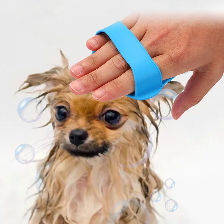Paw-shaped bath brush in use on a small dog in dog grooming set