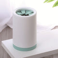 White dog paw cleaner cup with green silicone bristles and green base
