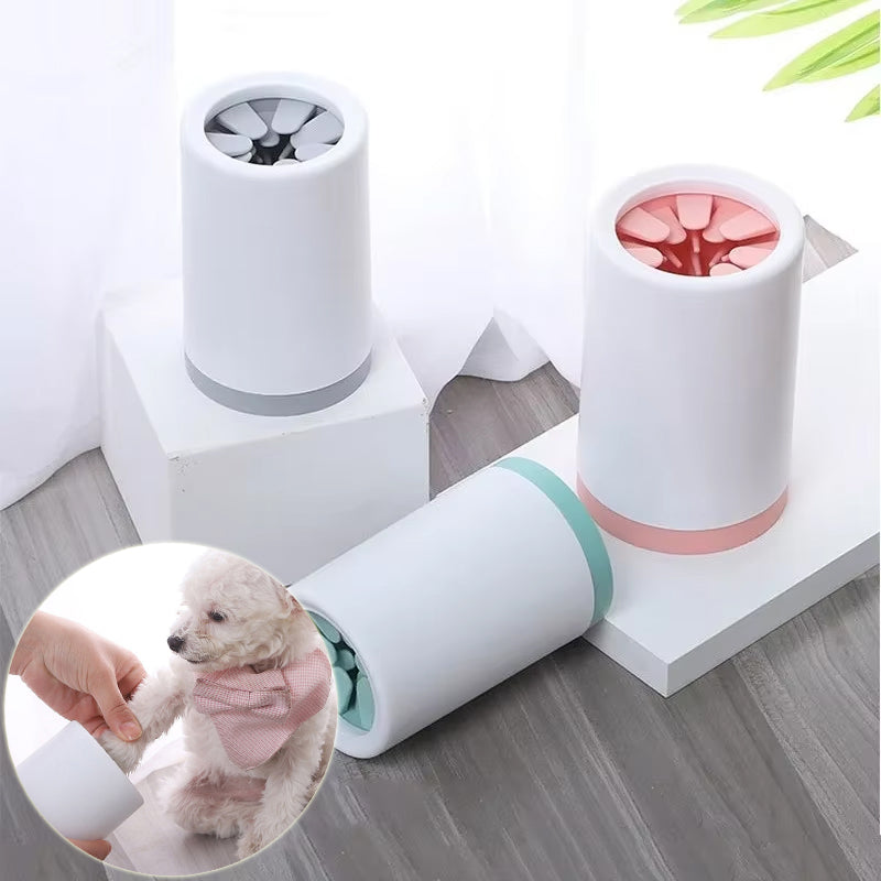 Paw cleaner cups in grey, pink and green, with a small dog having a paw cleaned